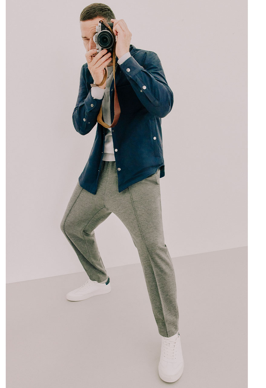 Fred Sirieix taking a photograph wearing oatmeal joggers and a navy shacket.