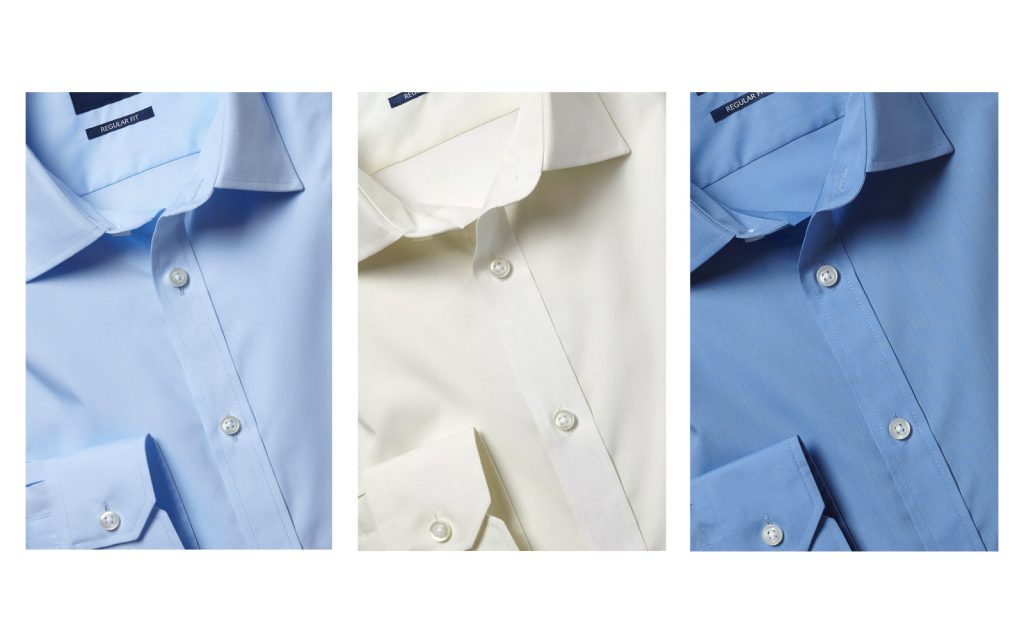 Row of different coloured poplin shirts. 