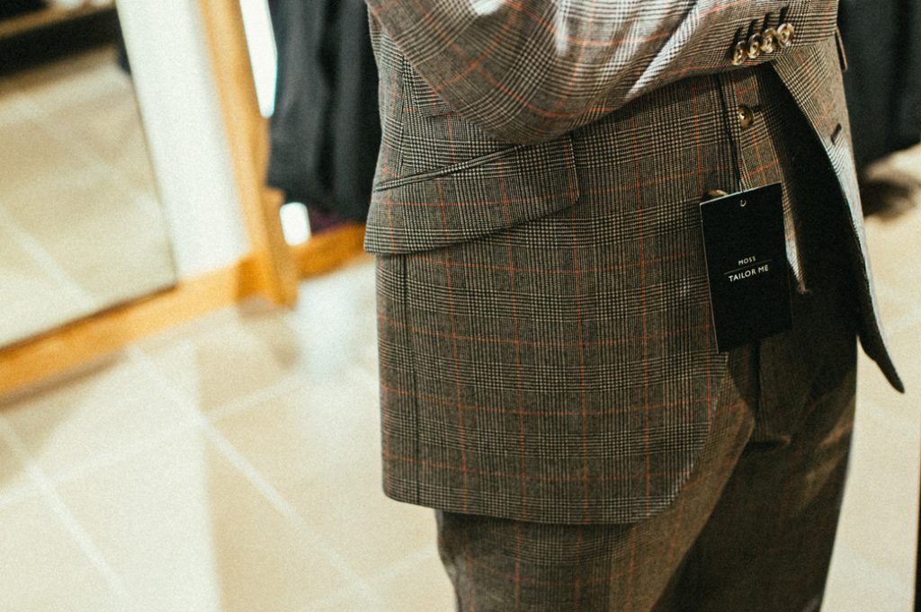Man buying a grey checked suit 