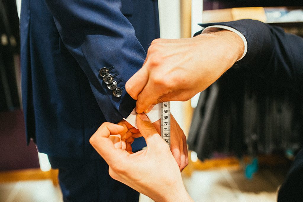 Man having his suit fitted by a tailor