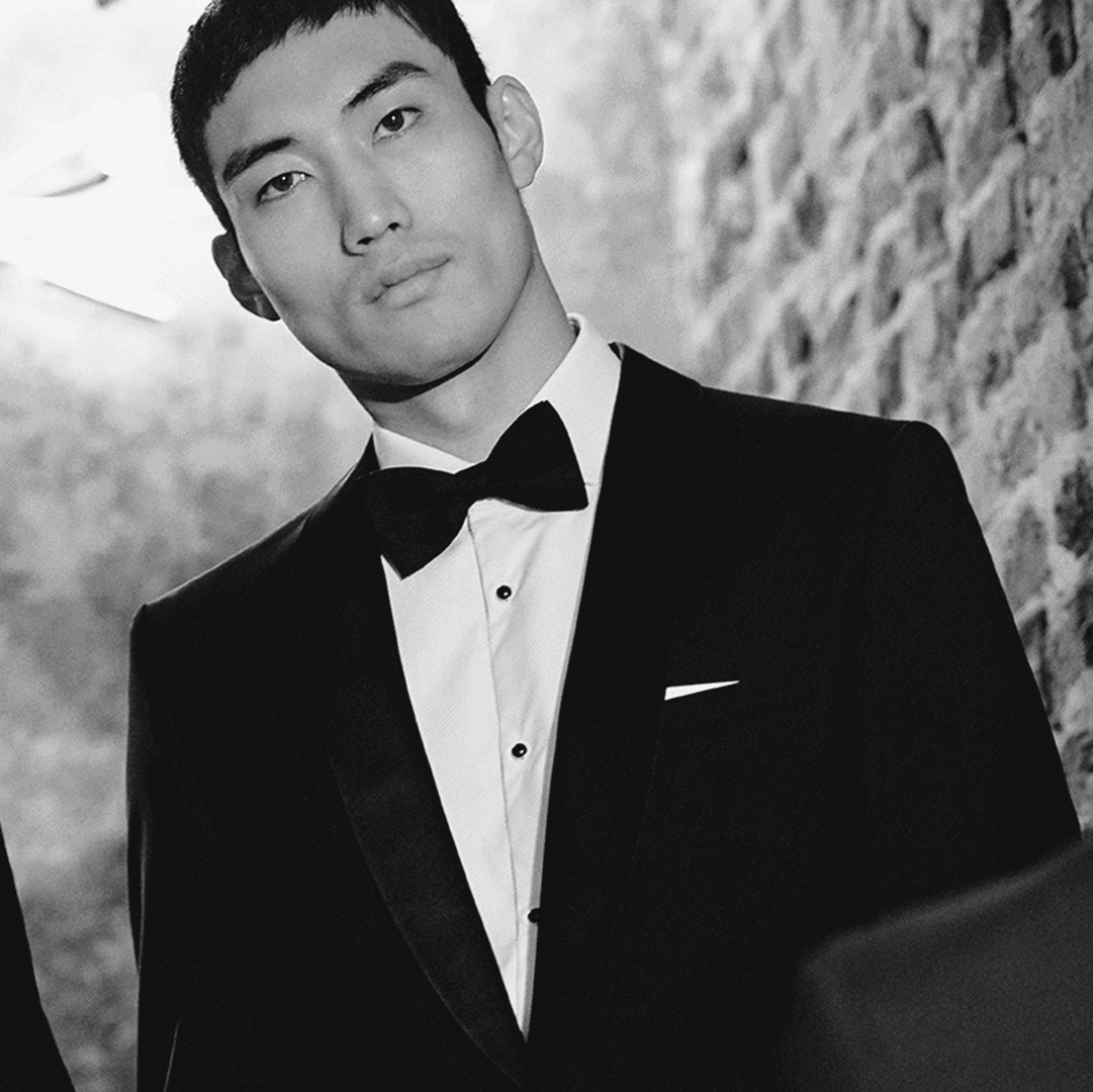 Black and white images of men in black tie suits and perfectly tied bow ties.