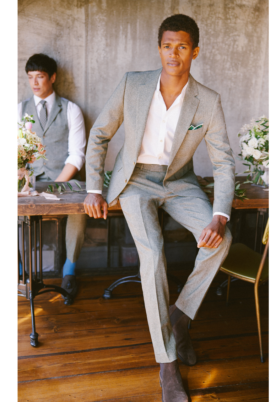 Two men in light grey wedding suits ready for a summer wedding.
