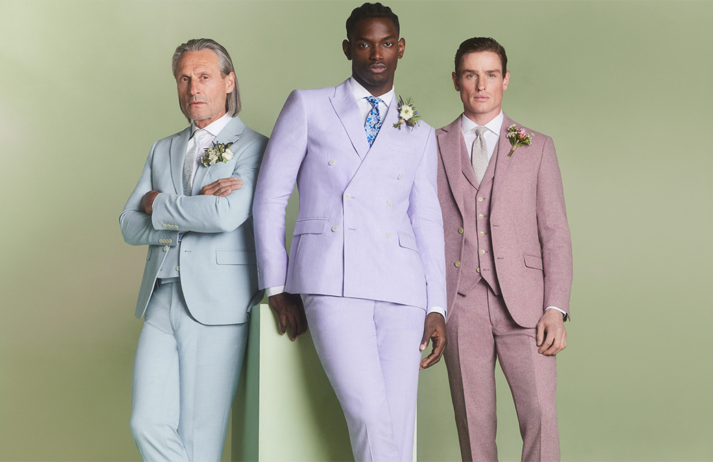 Smiling men walking in grey summer wedding suits 