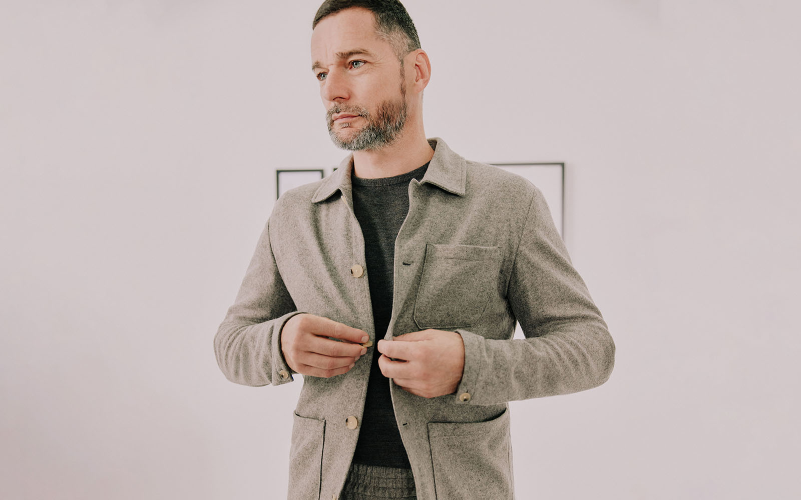 Fred Sirieix buttoning up an oatmeal Moss Bros shacket.