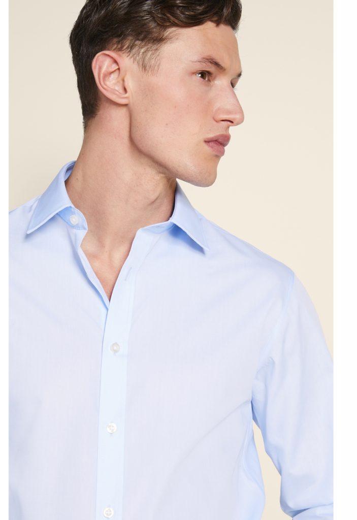 Man in light blue poplin shirt. 