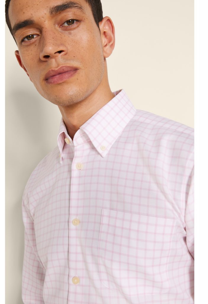 Man in white checked twill shirt looking at the camera. 