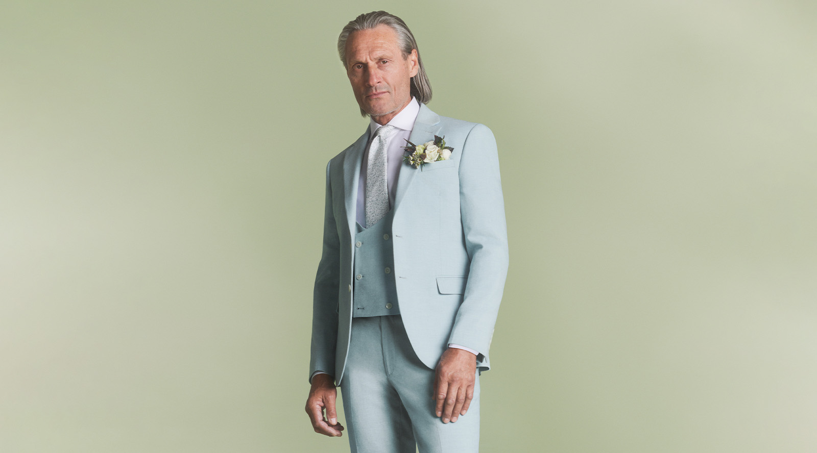 Groom in Moss sky blue summer suit. A modern groom's outfit recommended for a groom opting for a contemporary look.