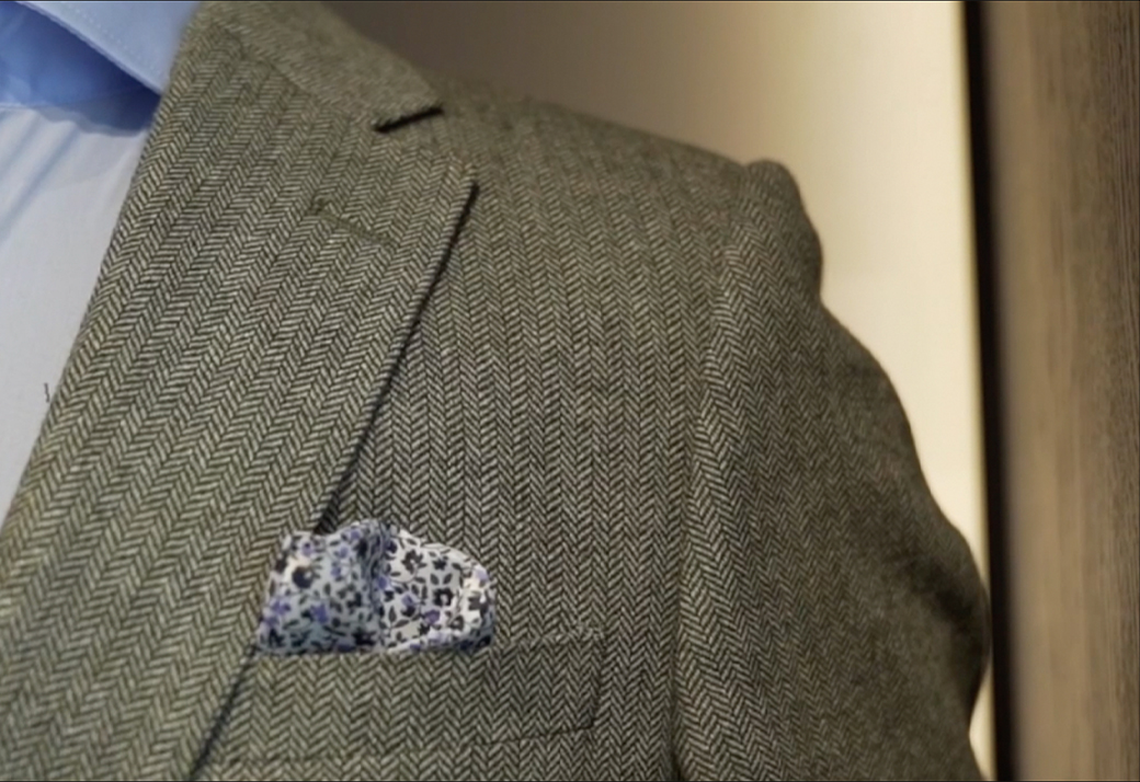 Man having his suit fitted by a tailor