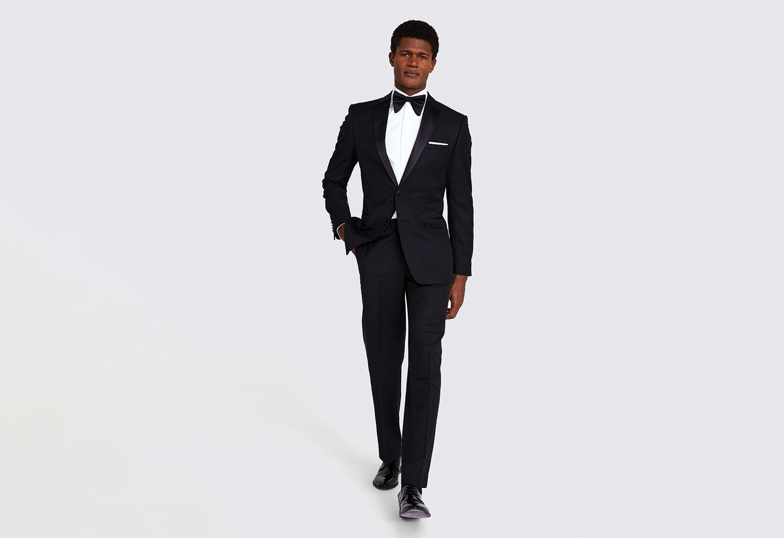 What to wear to get married abroad ; a groom wears a grey wedding suit for a summer wedding